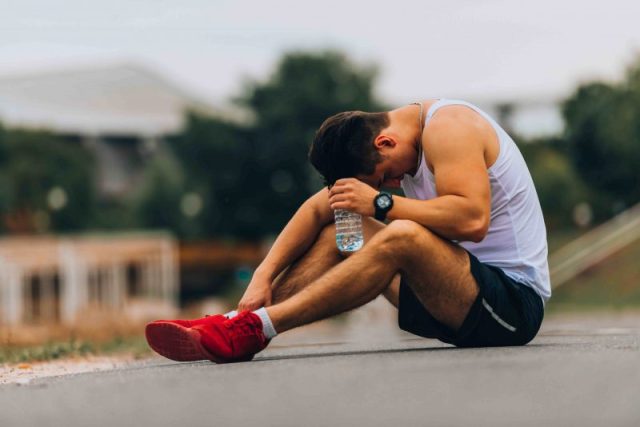 athlete resting with head down