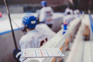 hockey players sit on the bench in the stadium