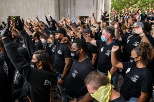 Crowd protests with fists in the air