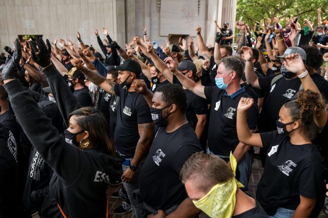 Crowd protests with fists in the air