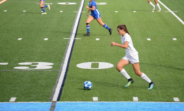 Soccer. Left wing carrying the ball up the field