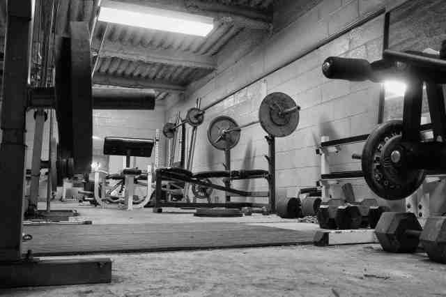 Black and white photo of a dirty, grungy ,hard core, weight room