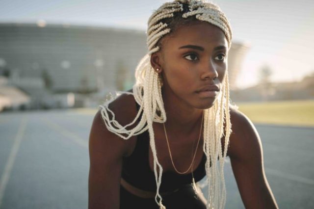 female sprinter ready to race on running track