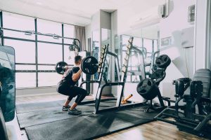 man lifting barbells