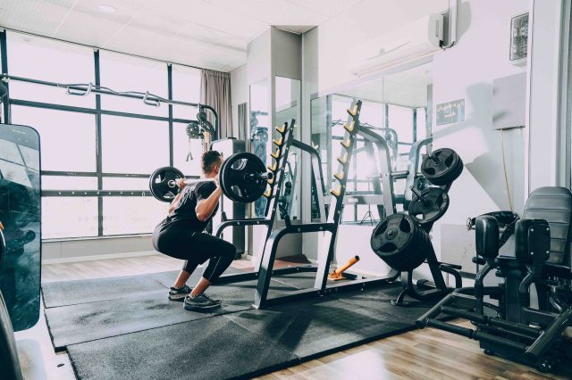 man lifting barbells