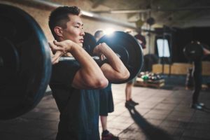several min lifting barbells in gym