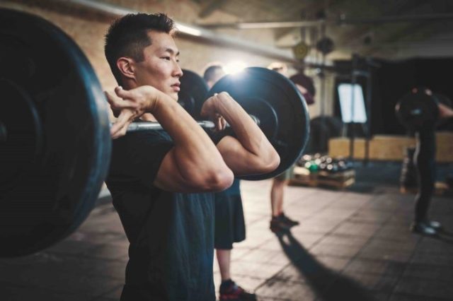several min lifting barbells in gym