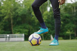 foot resting on soccer ball