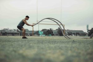 athlete working out with training ropes outdoors