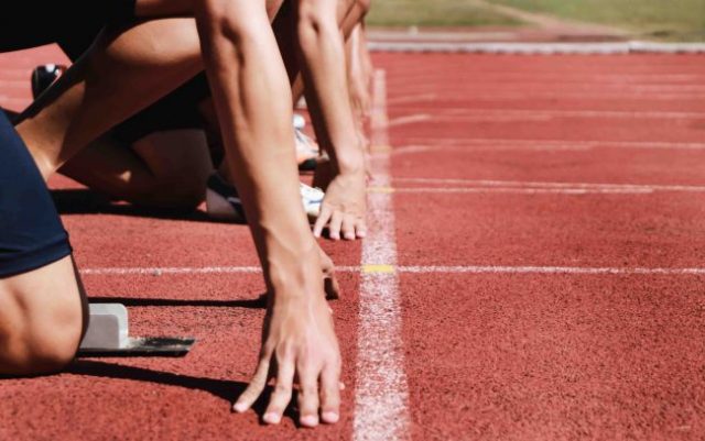 track athletes in their blocks on the start line