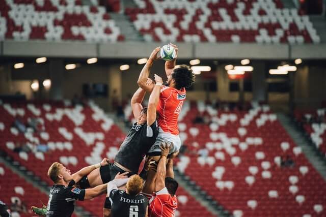 two teams grabbing for ball in the air
