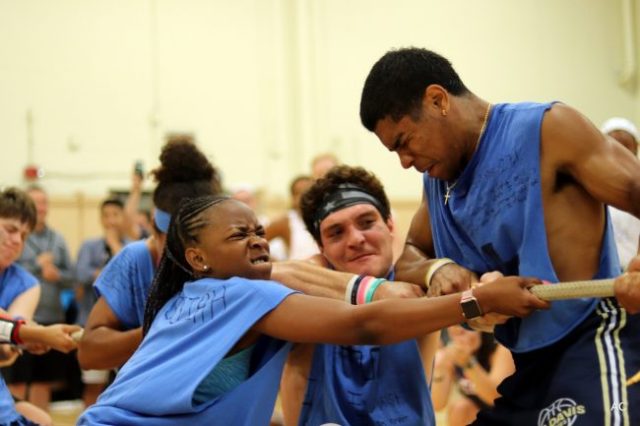 team straining to pull on a rope in a tug-of-war