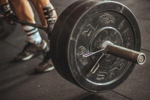 large weight on barbell barely lifted off the floor