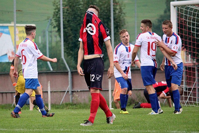 Goalie walking from goal with shirt pulled up over face