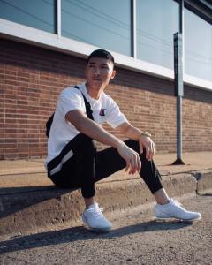 man sitting on street curb