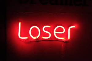 Neon sign says "Loser"
