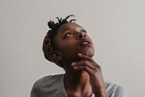woman in grey shirt looking up