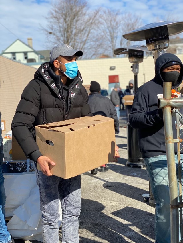 Pro soccer player Teal Bunbury gives food boxes to families in need in partnership with Providence Rescue Mission