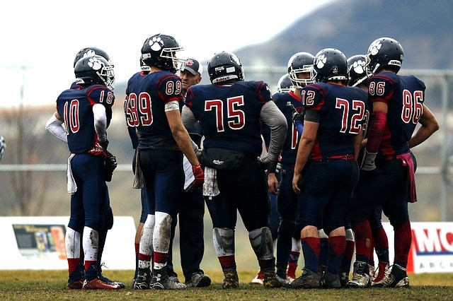 Football players huddled together