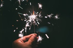 hand holding a lighted sparkler