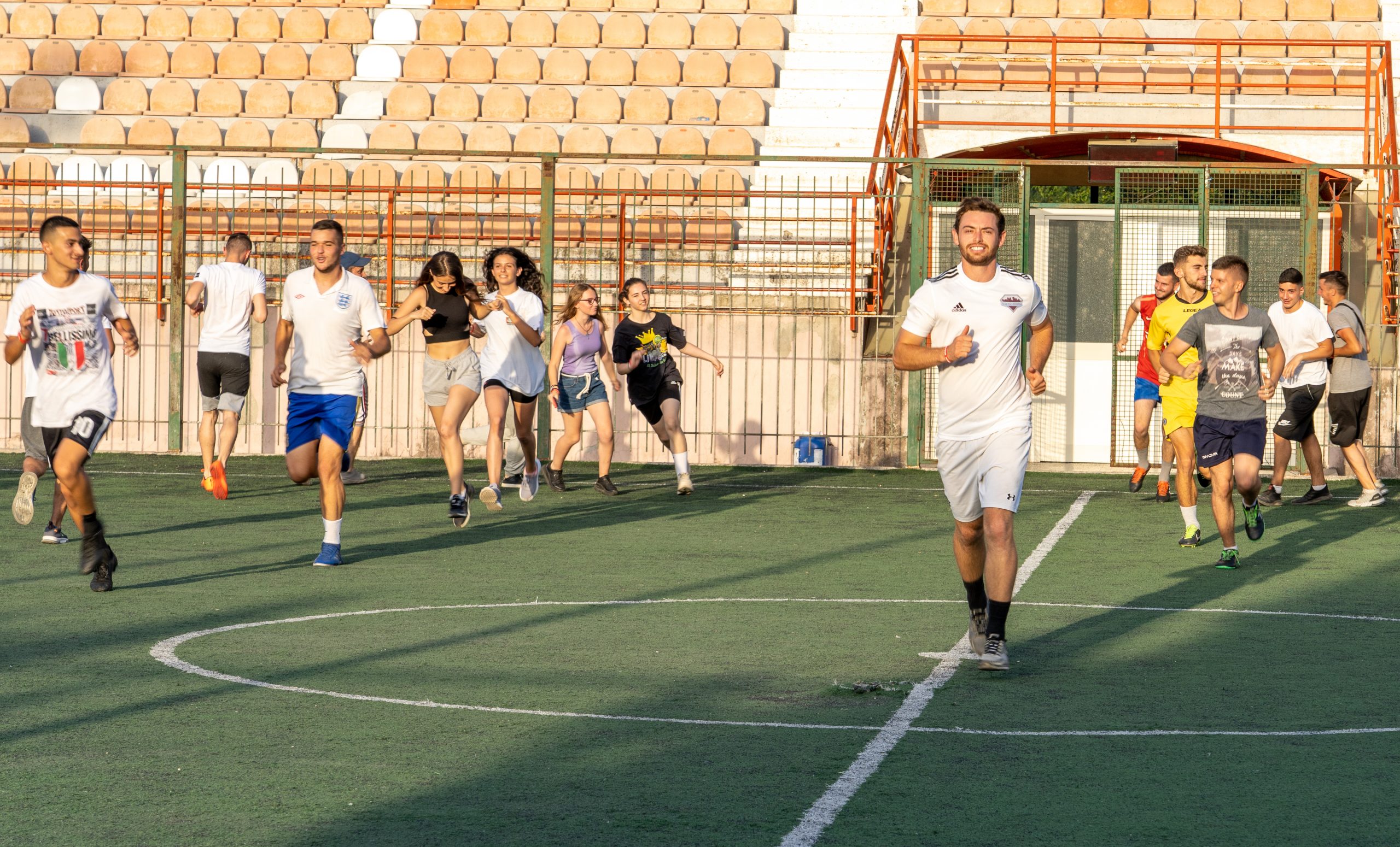 Male and Female Soccer Players Warming Up on the Field