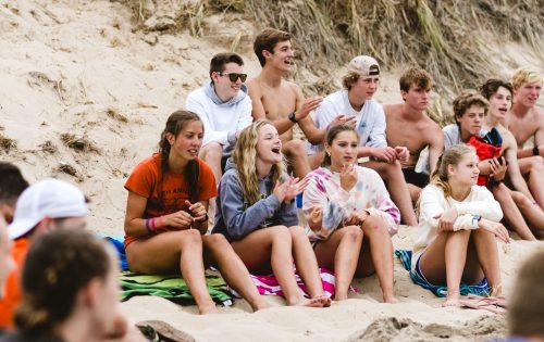 group of teenage athletes on beach