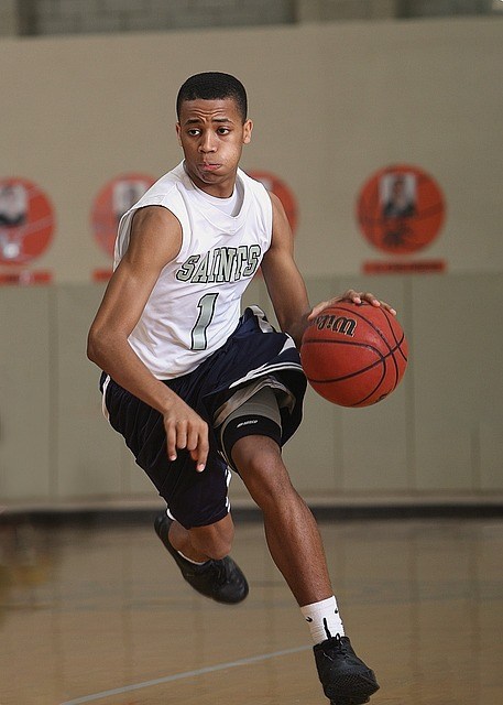 man on a basketball court running with a basketball