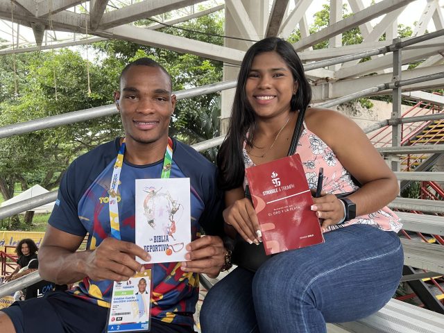Two people holding Bibles