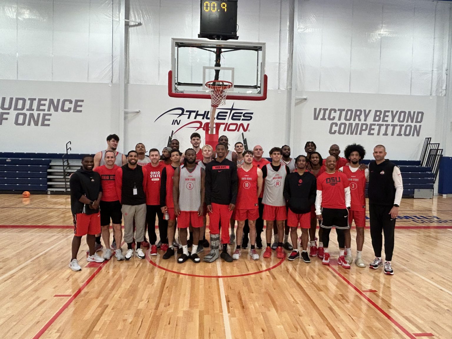 College basketball team posing on the Fieldhouse court