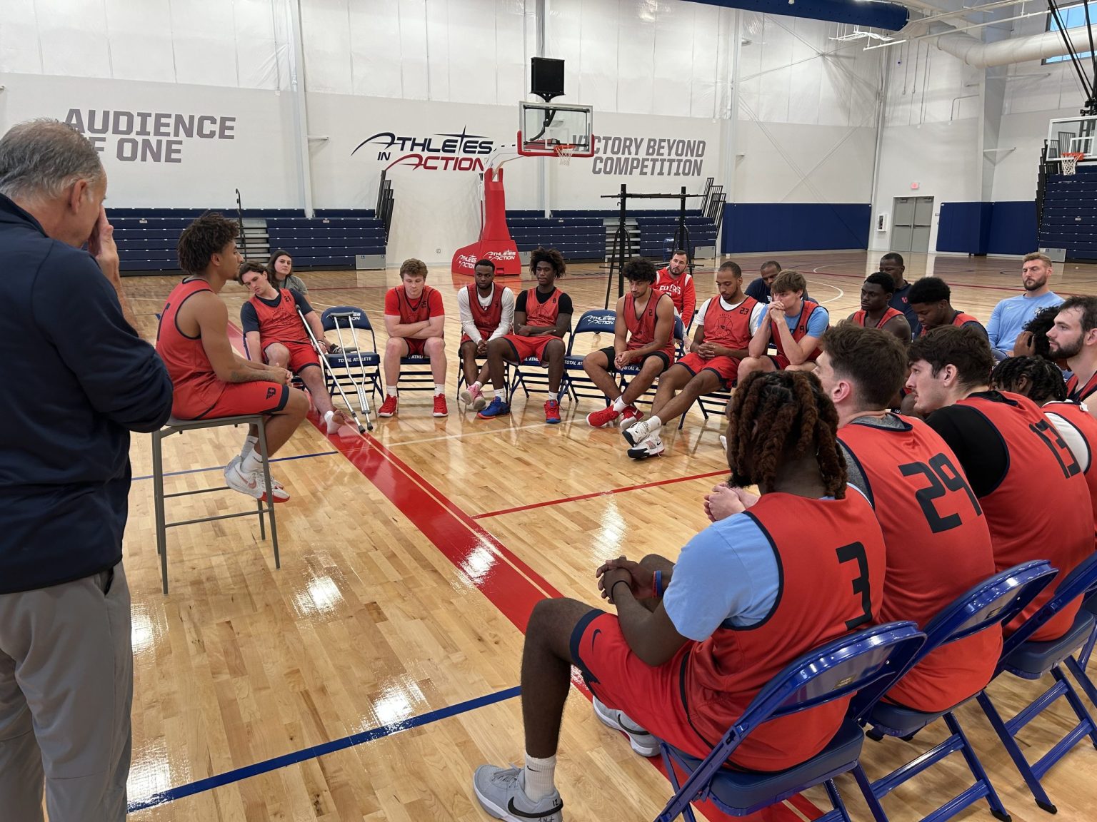College basketball team seated in the Fieldhouse during a team retreat session