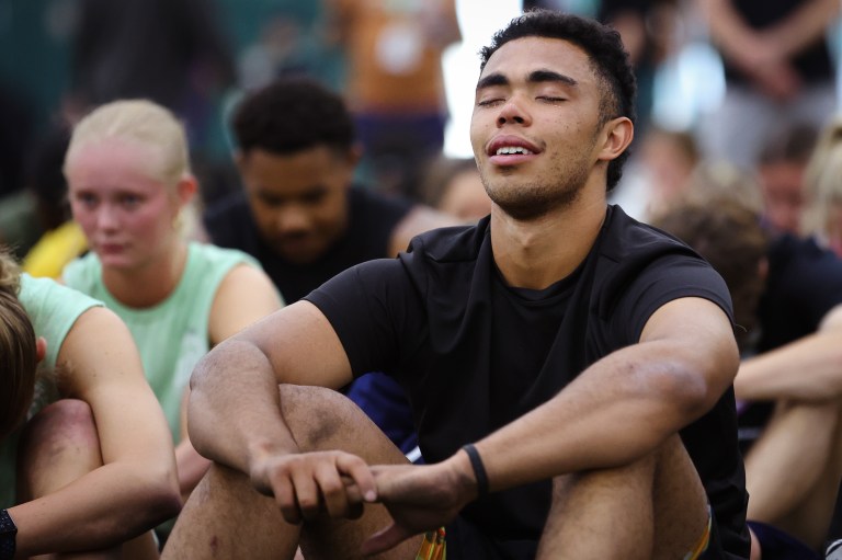 Athlete closing his eyes during worship and smiling