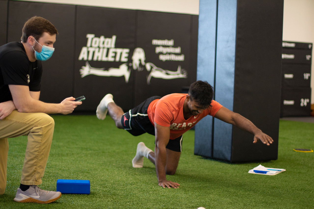 Trainer coaching an athlete in the AIA Sports Performance Center