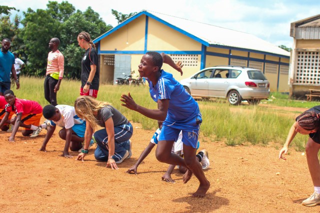AIA athlete teaching sprint starts to young athletes in Kpalime, Togo