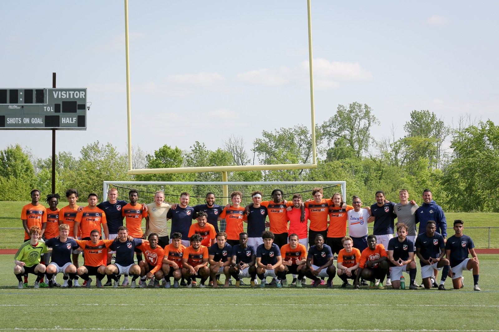 An AIA soccer team posing together on the field