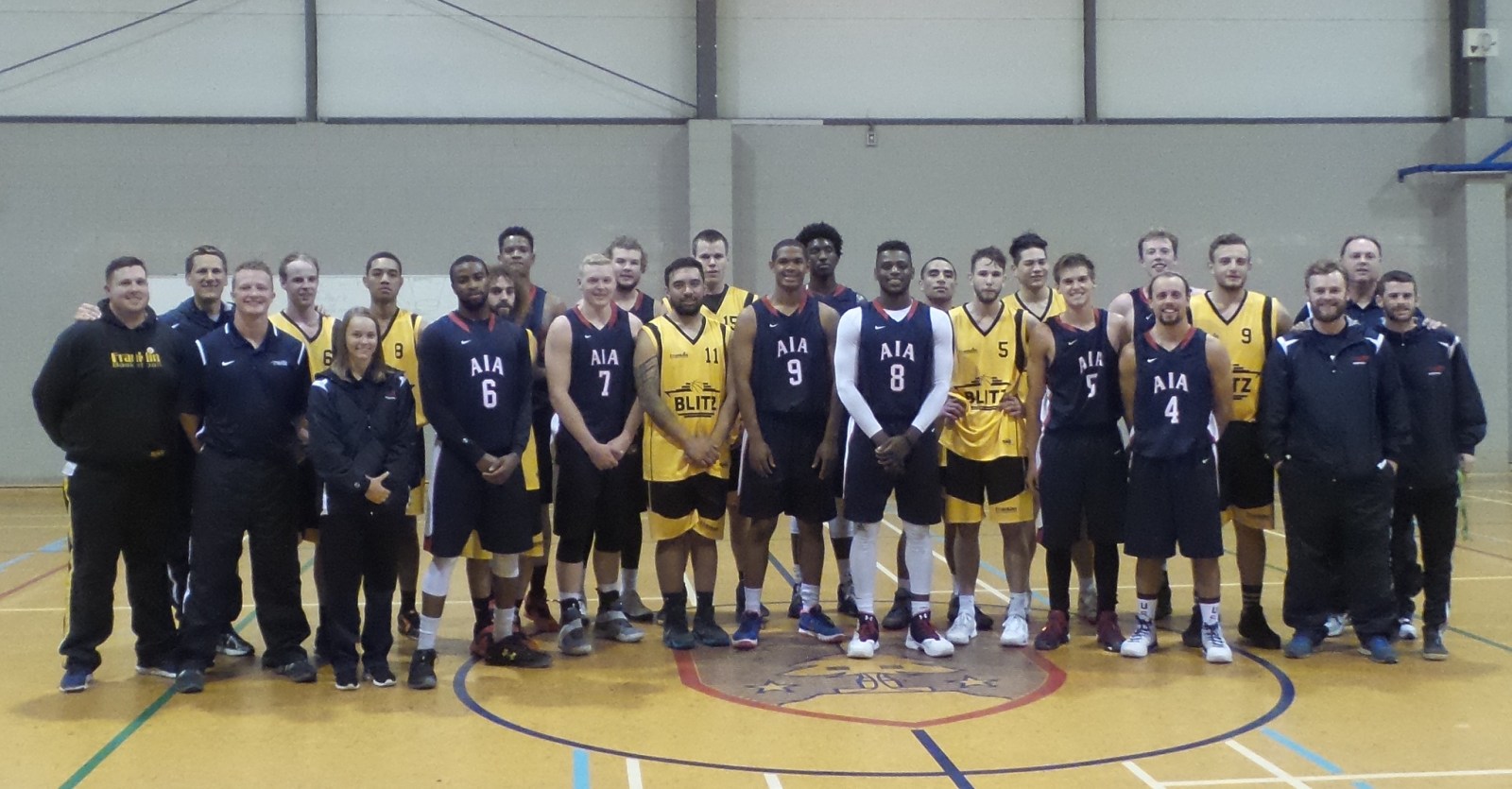 An AIA basketball team posing together on a trip to New Zealand