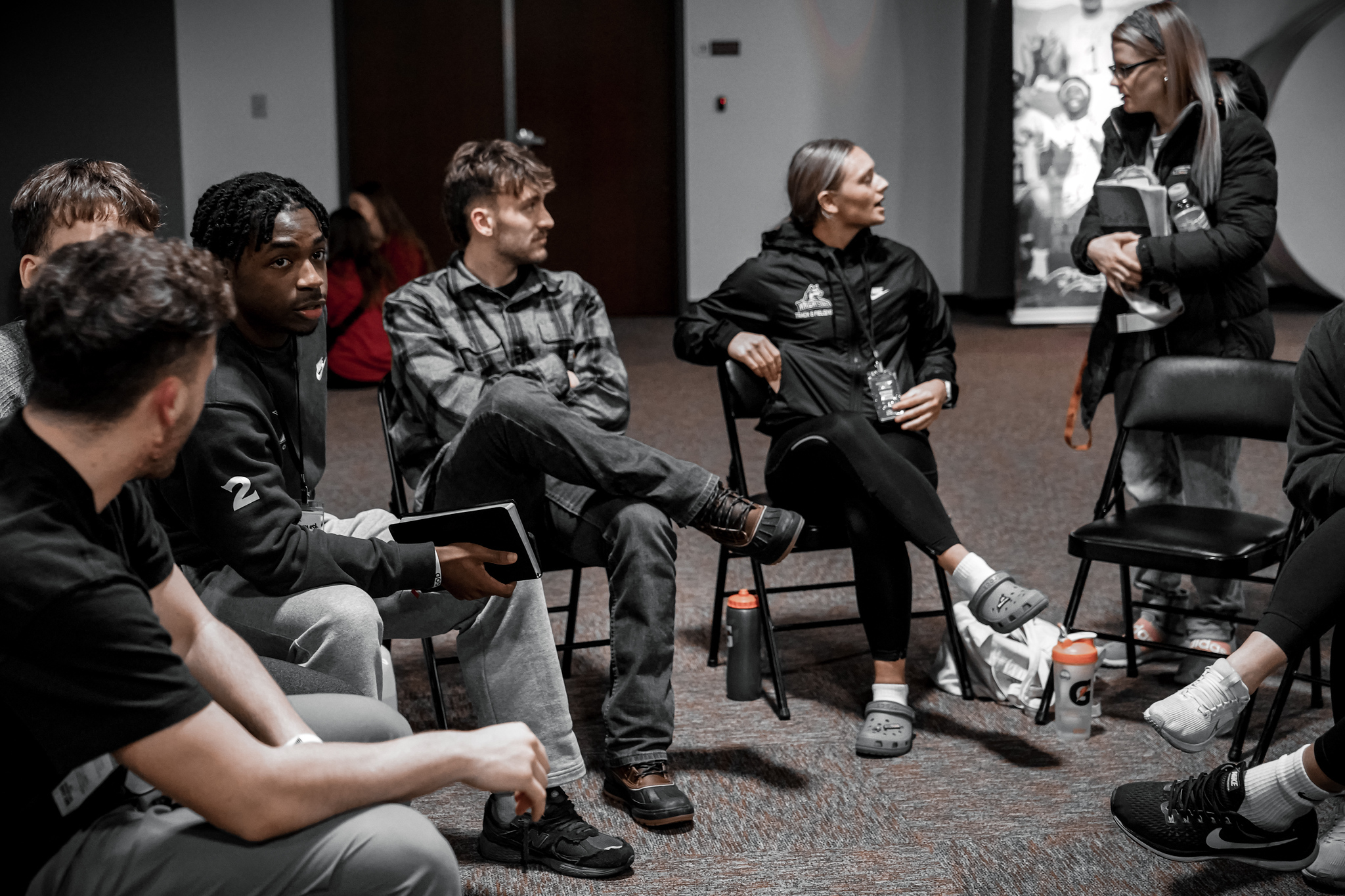 College athletes sitting in a small group circle at an AIA winter retreat