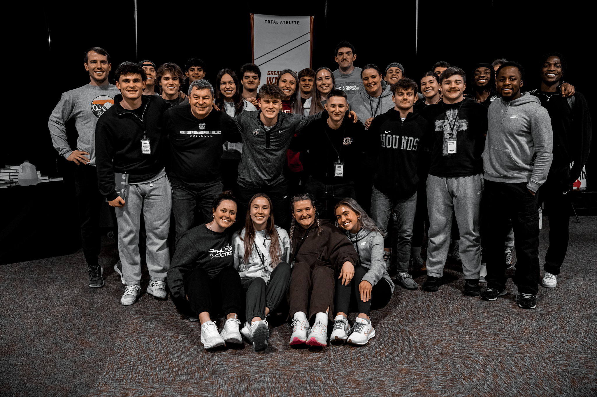 A large group of college athletes posing together at an AIA winter retreat