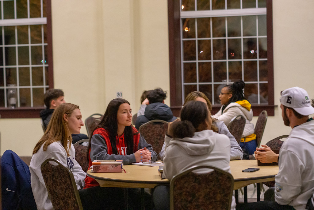 Athletes in a small group study at a winter retreat