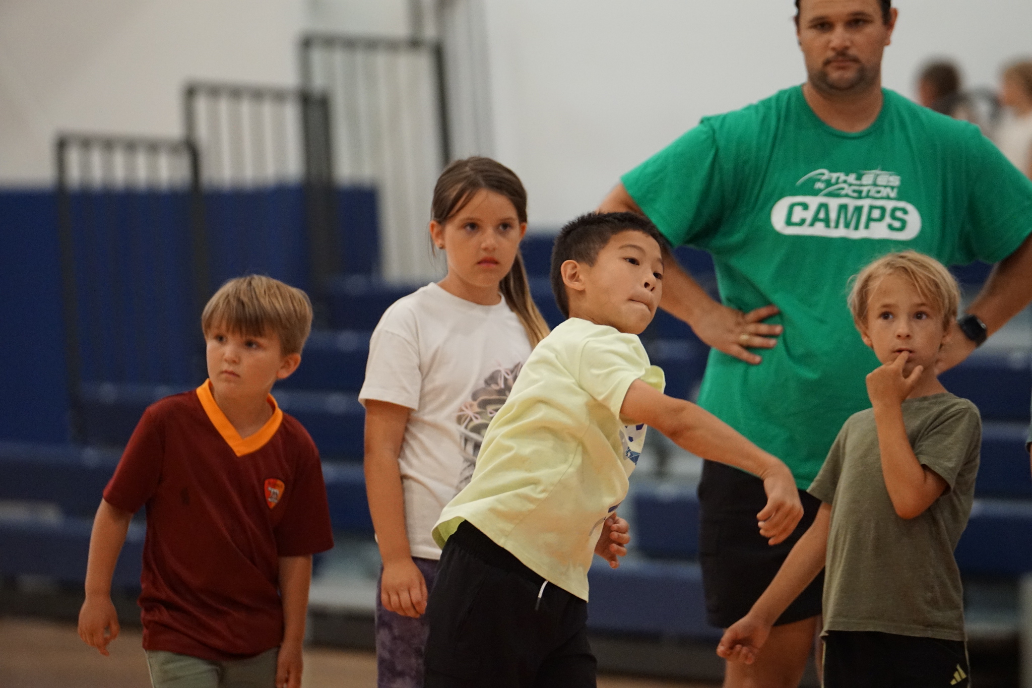 Young campers in a gym with an AIA Camps coach