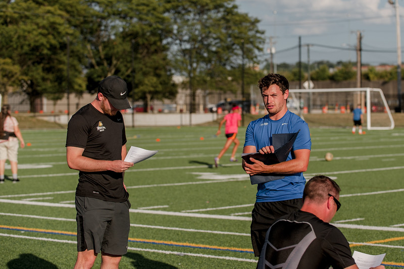 Coach with players at a soccer outreach