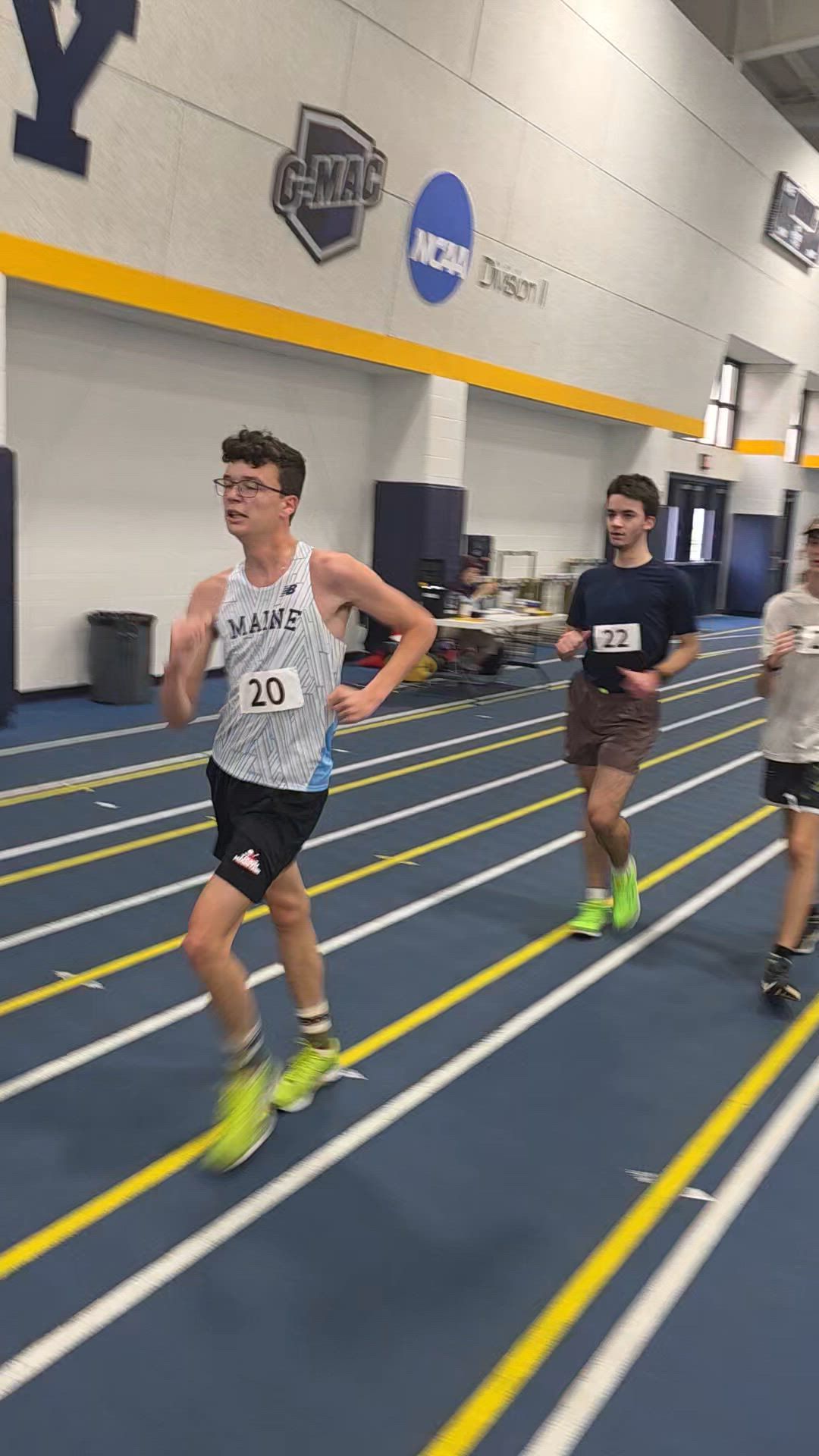 High school race walkers competing on an indoor track at an AIA training camp