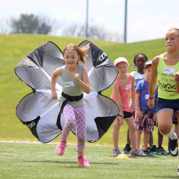 Girl sprinting with parachute