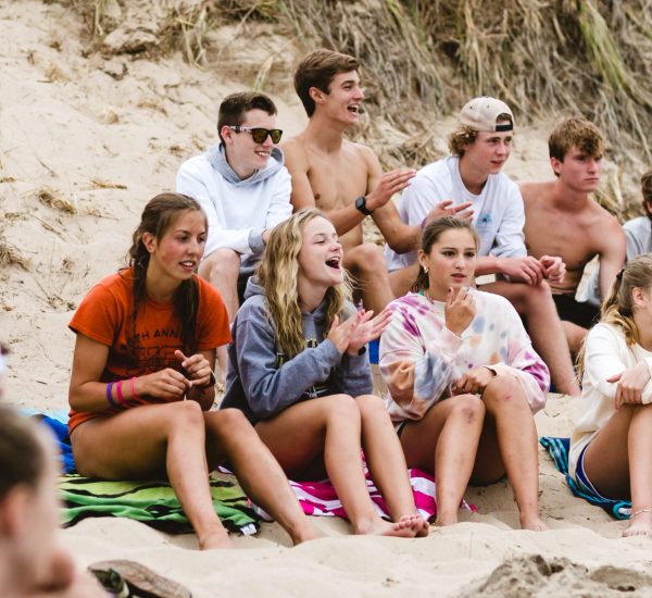 group of teenage athletes on beach